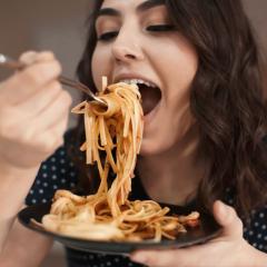 Lady eating pasta